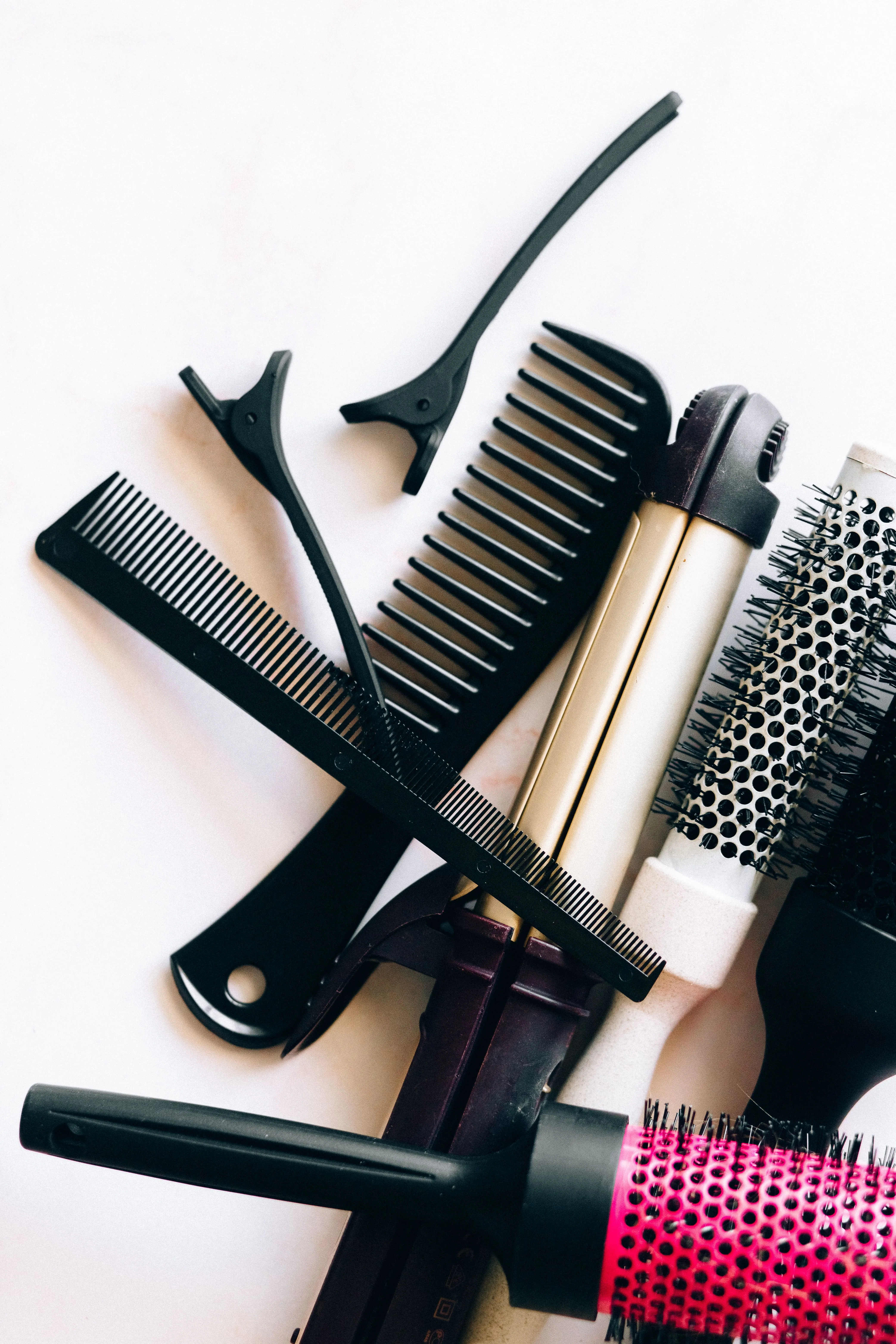 Salon tools — combs, clips, and a curling iron