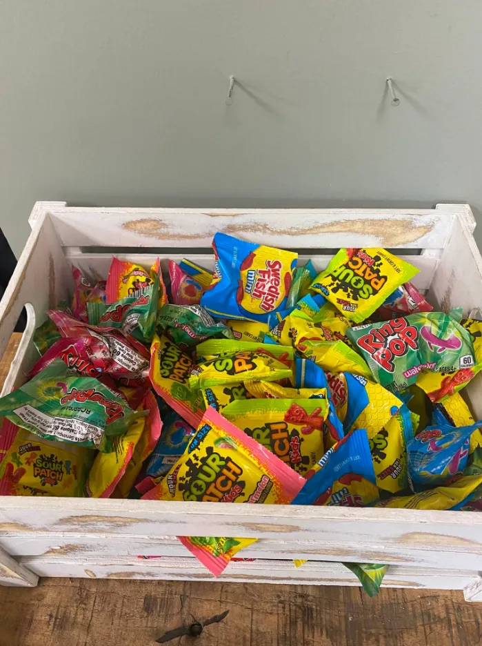 A crate full of candy for kids after their haircut