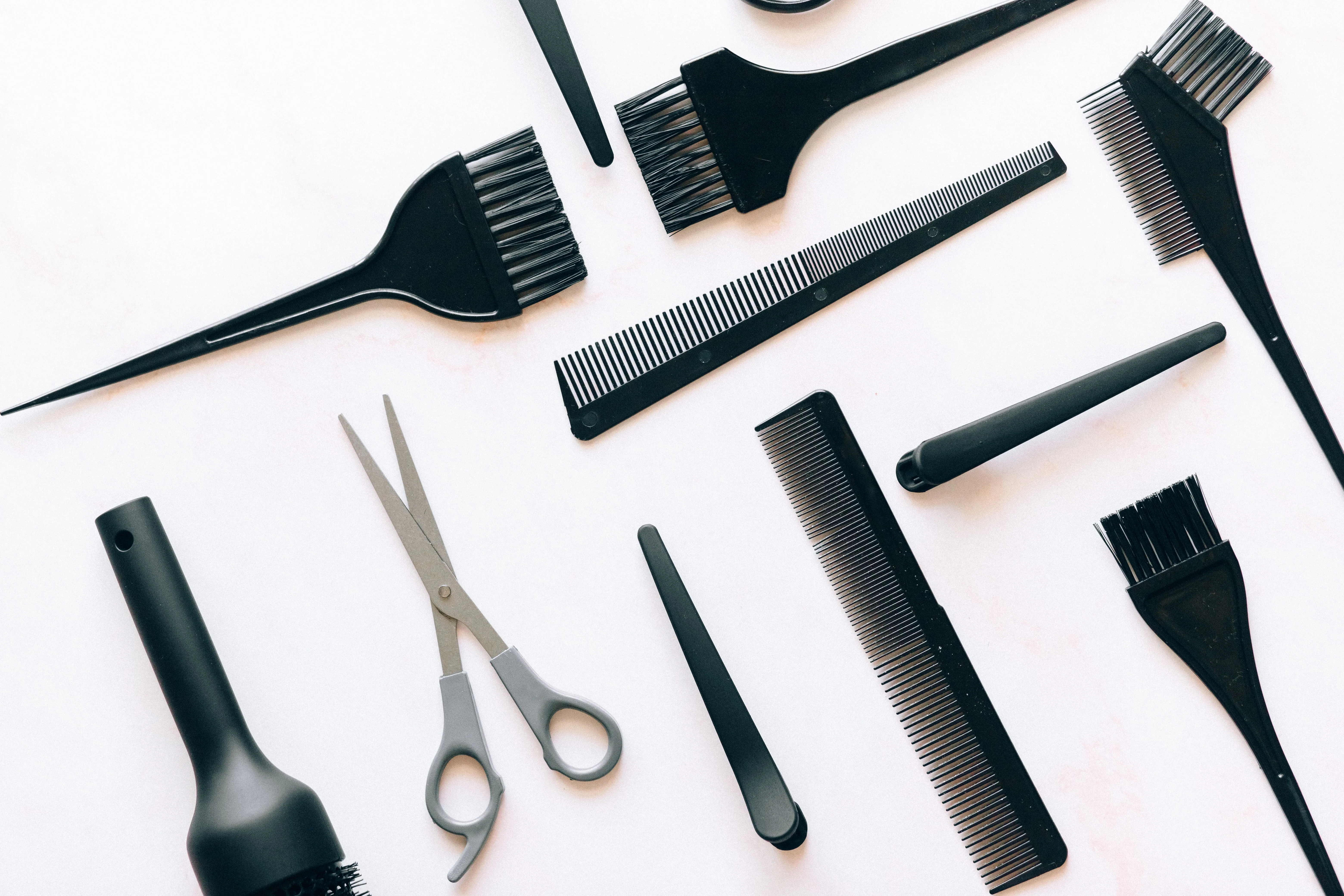 Salon tools laid out — scissors, combs, and color brushes